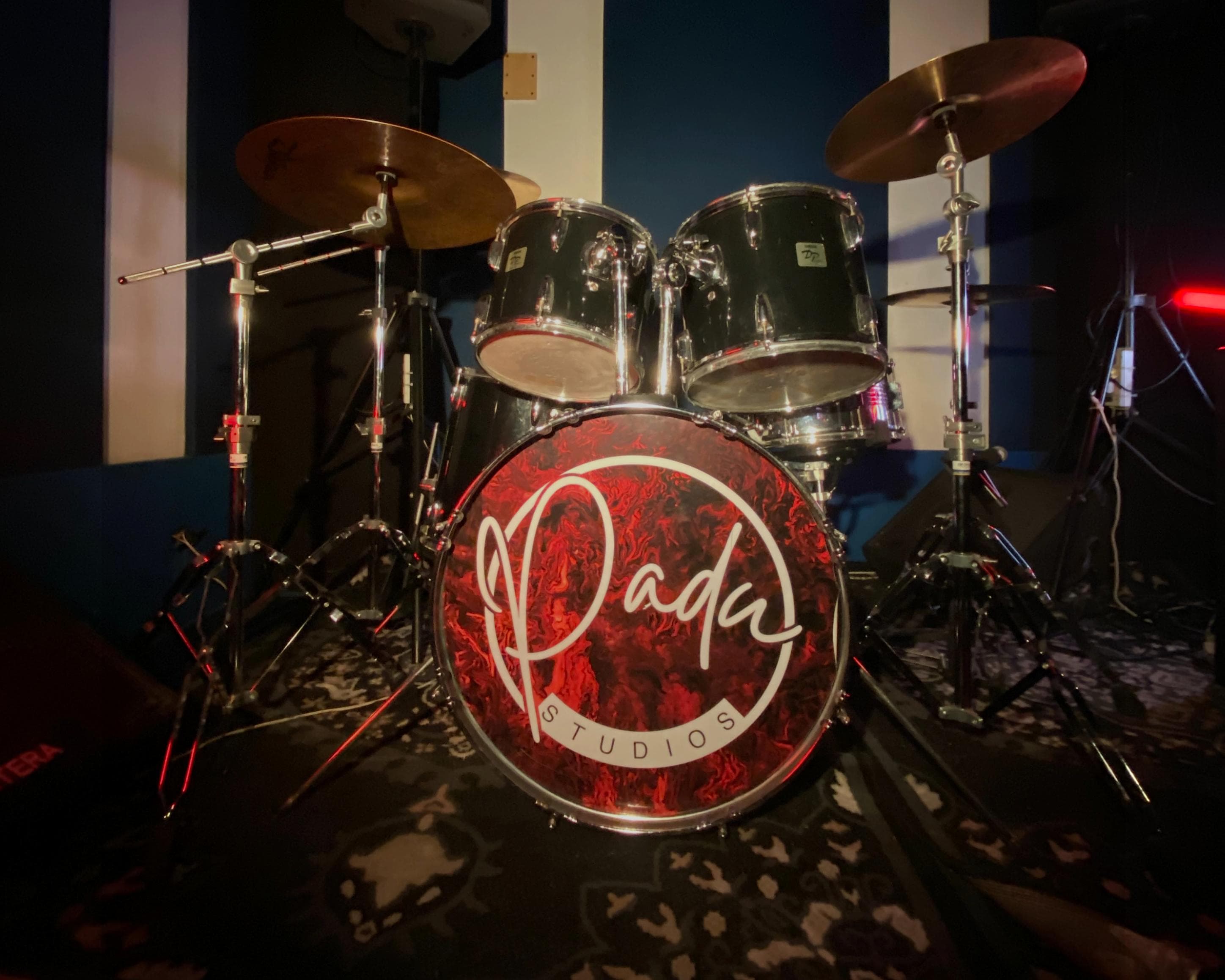 Drum set in a recording studio, pre-cropped for the hero section.