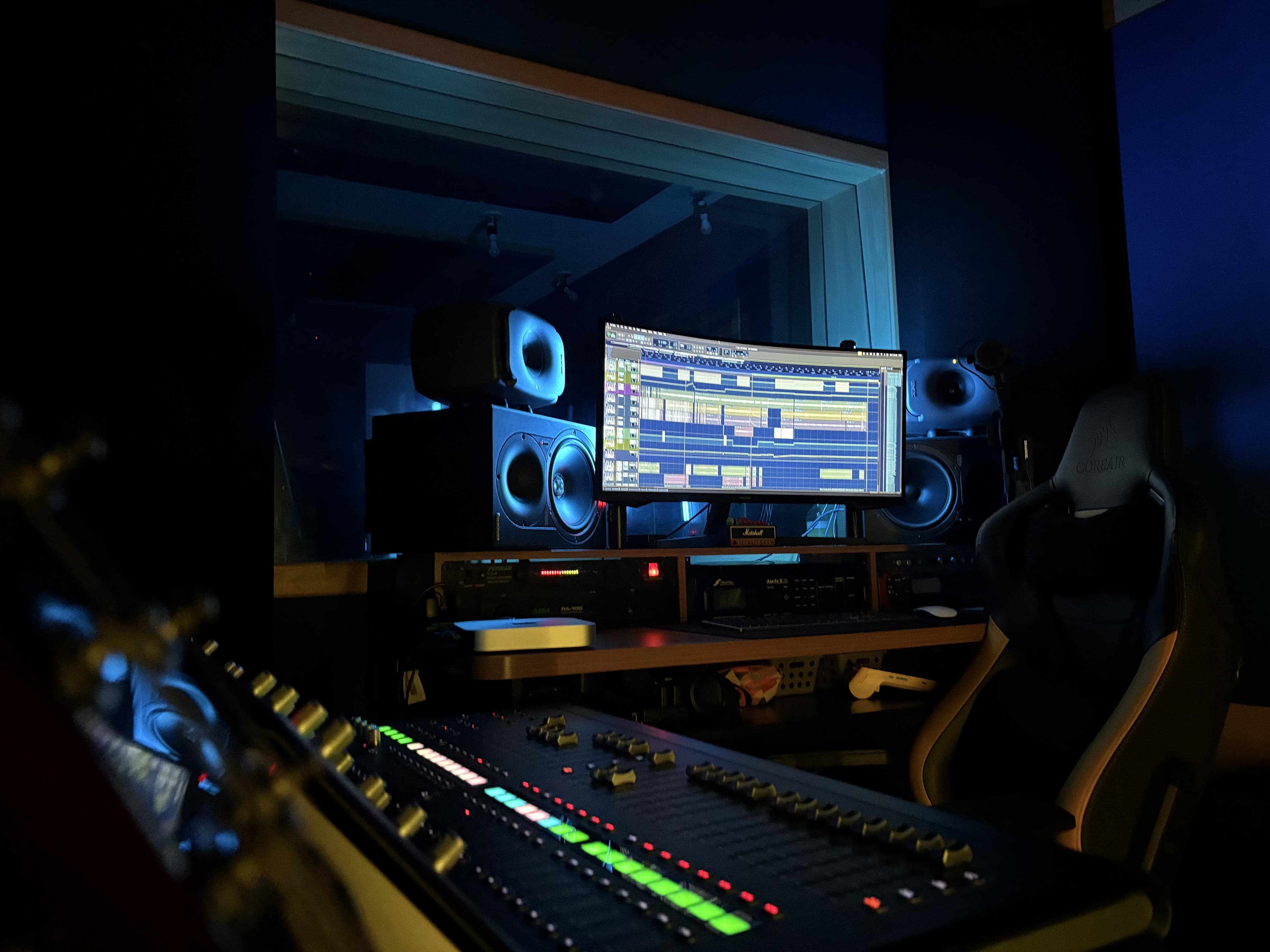 Close-up of an audio interface and studio monitors.